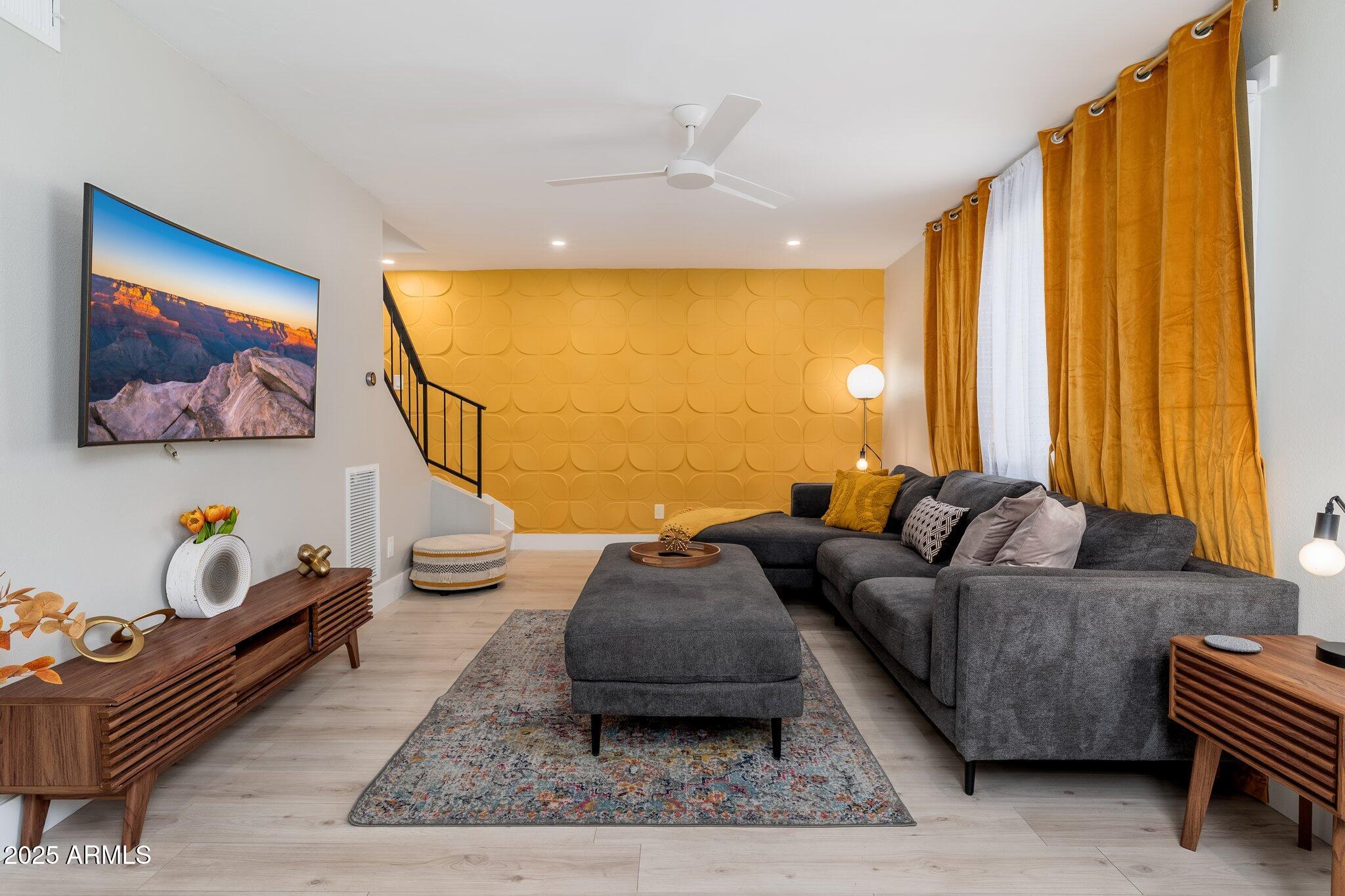6957 East Osborn Road, Unit A Scottsdale, AZ 85251 - Photo 3 of 29 a living room with furniture and a flat screen tv