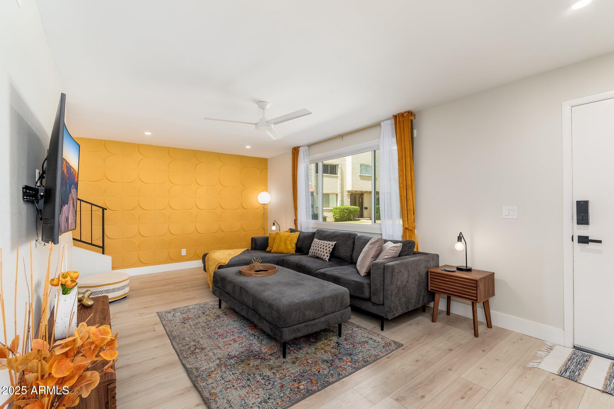 6957 East Osborn Road, Unit A Scottsdale, AZ 85251 - Photo 4 of 29 a living room with furniture and a flat screen tv