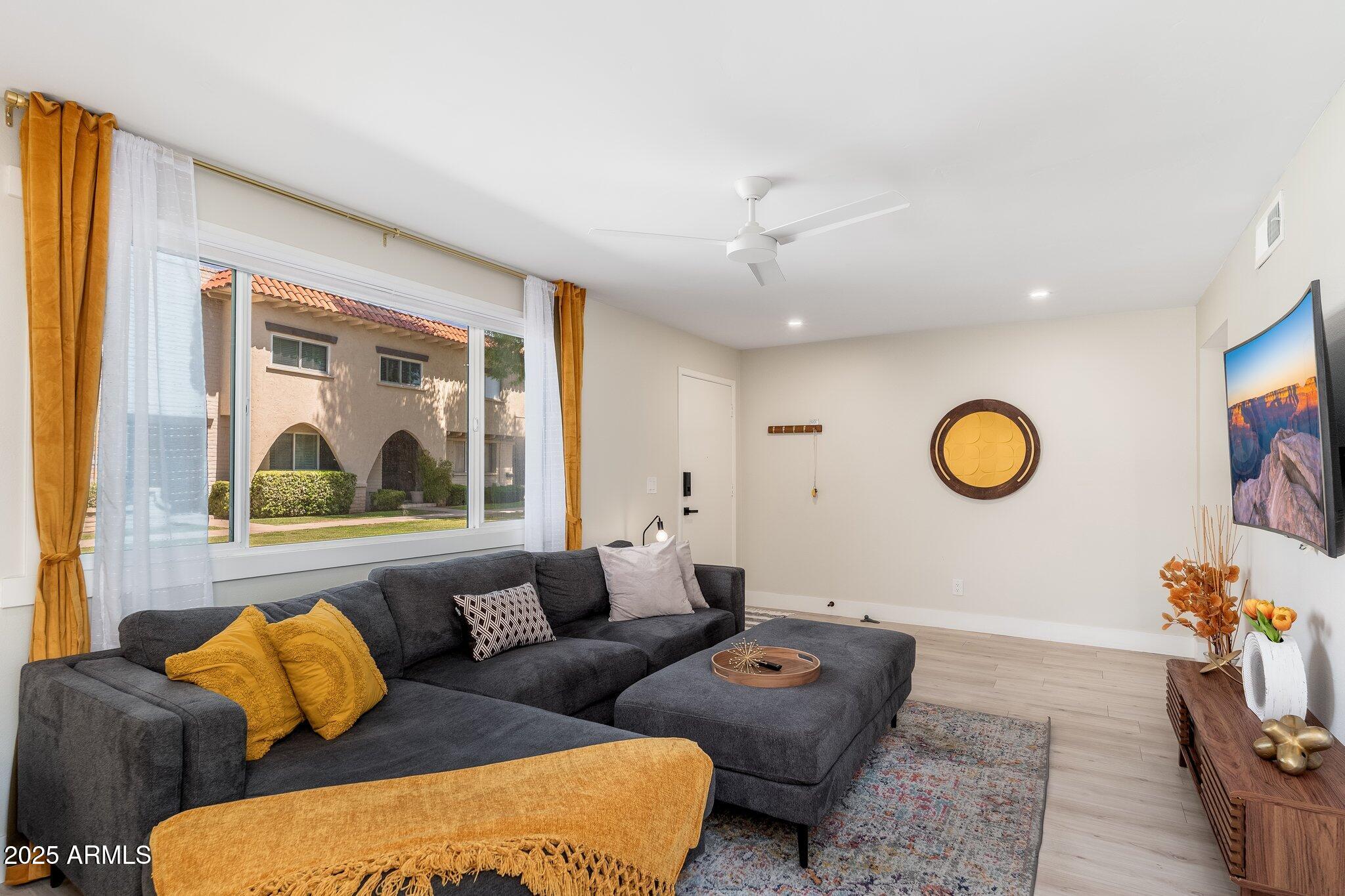 6957 East Osborn Road, Unit A Scottsdale, AZ 85251 - Photo 6 of 29 a living room with furniture and a large window