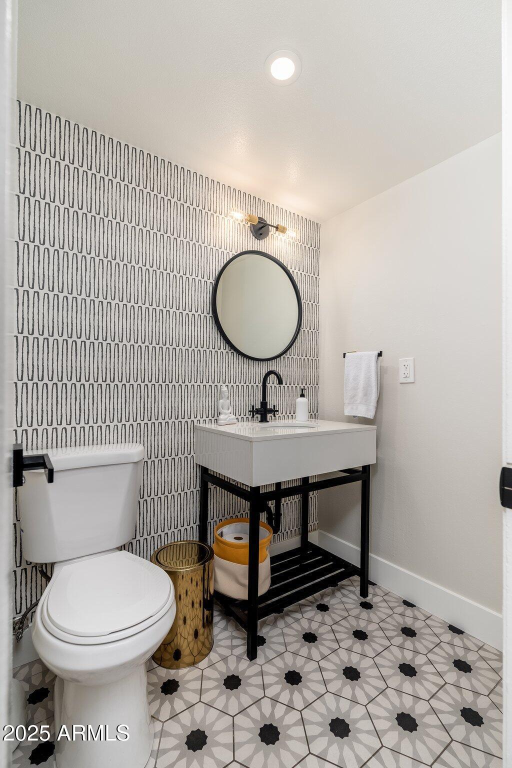 6957 East Osborn Road, Unit A Scottsdale, AZ 85251 - Photo 8 of 29 a bathroom with a toilet a sink and mirror