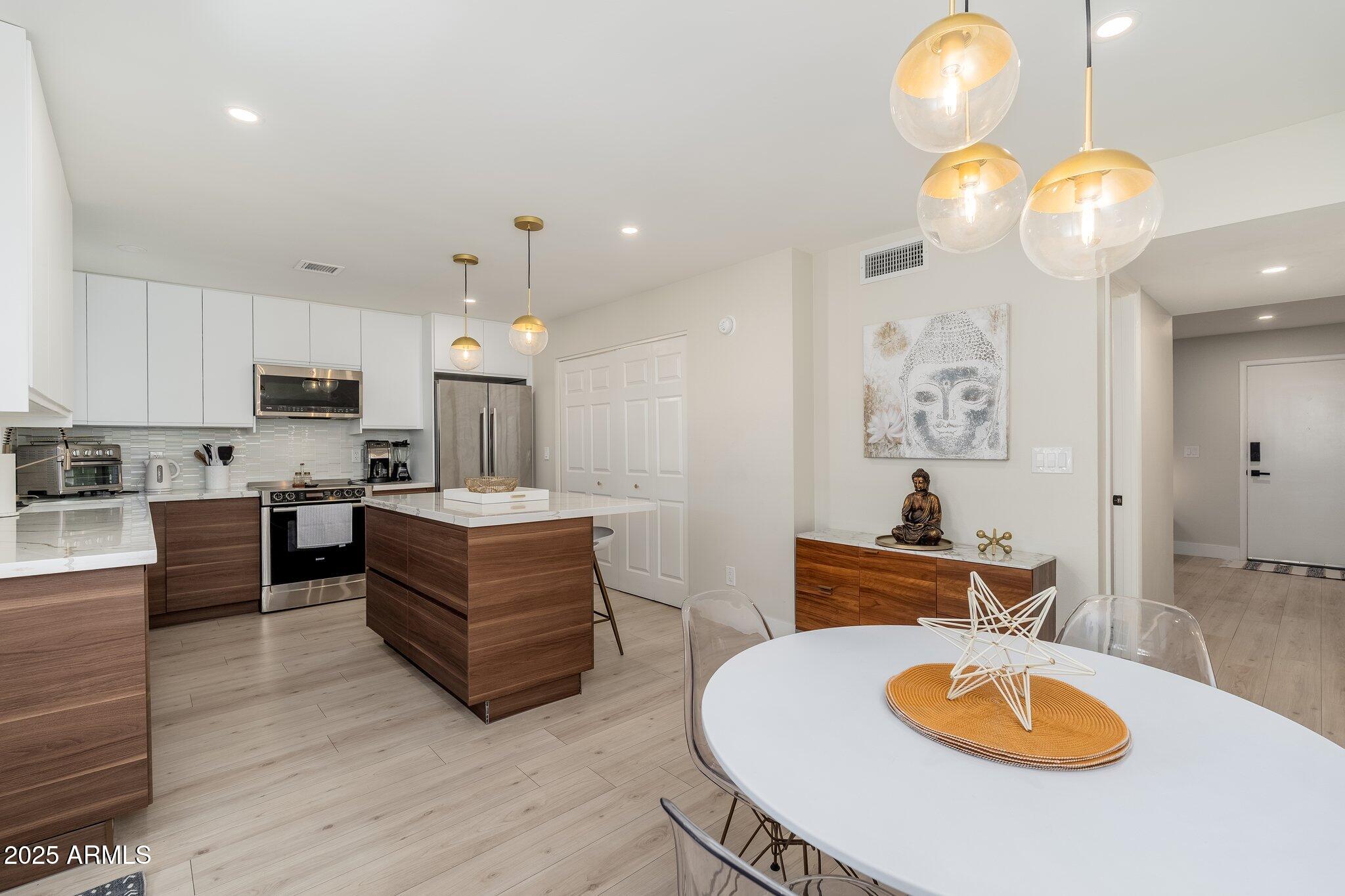6957 East Osborn Road, Unit A Scottsdale, AZ 85251 - Photo 9 of 29 a living room with furniture and a wooden floor