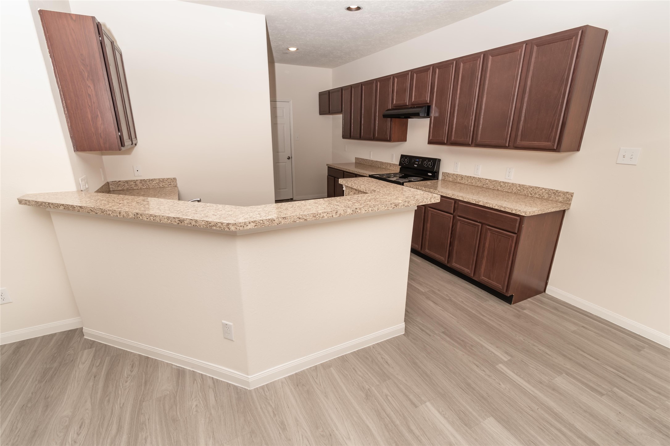 3918 Calgary Circle Missouri City, TX 77459 - Photo 2 of 9 a kitchen with stainless steel appliances granite countertop a sink a microwave counter space and wooden floor