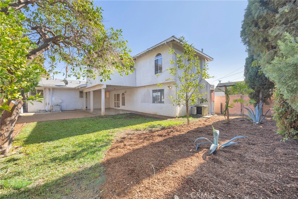 1128 South Parton Street Santa Ana, CA 92707 - Photo 15 of 17 a front view of a house with a yard and garage