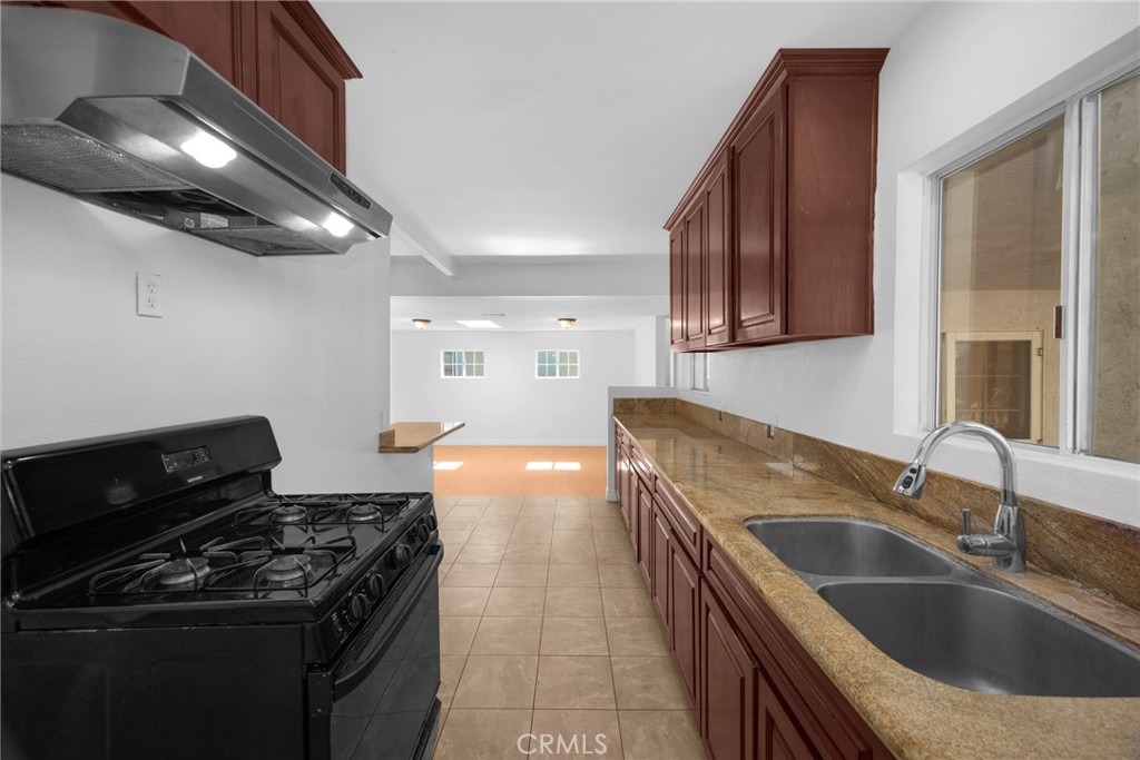 1128 South Parton Street Santa Ana, CA 92707 - Photo 6 of 17 a kitchen that has a sink and a stove