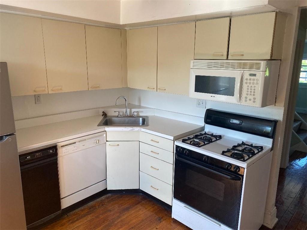 a kitchen with cabinets and appliances