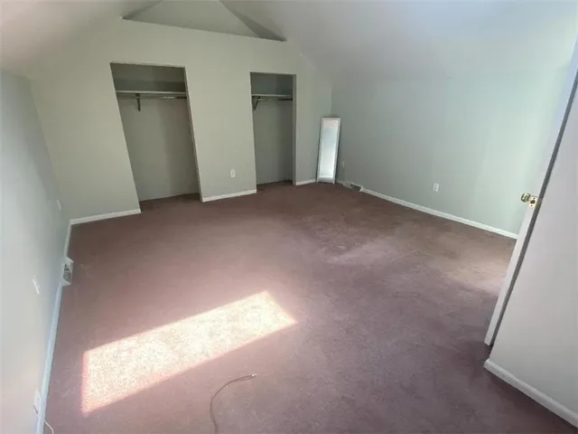 a view of an empty room and a window
