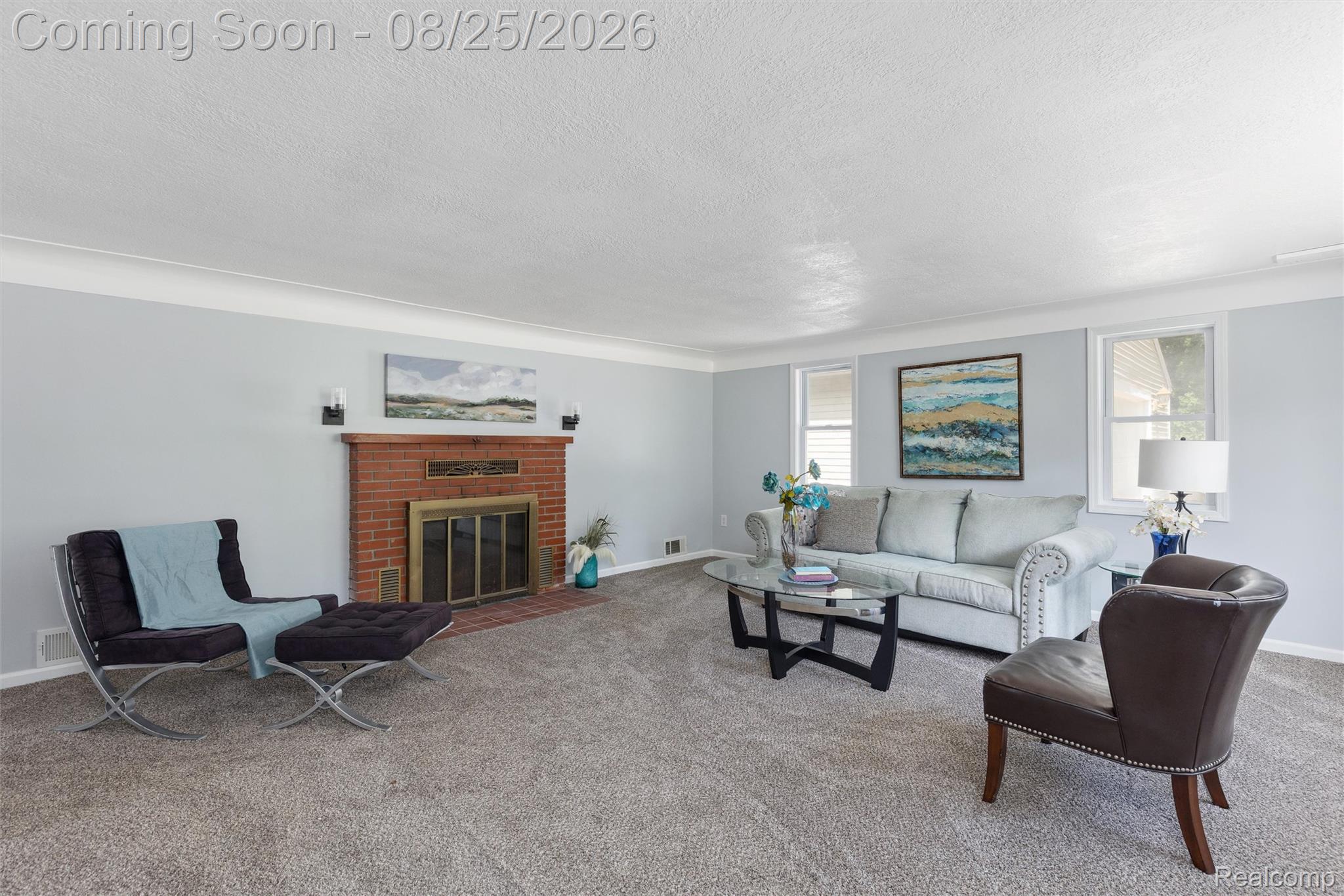 1156 Rinn Street Burton, MI 48509 - Photo 6 of 25 Living space featuring a brick fireplace with a metal insert, light gray wall paint, white crown molding, and two windows with white blinds