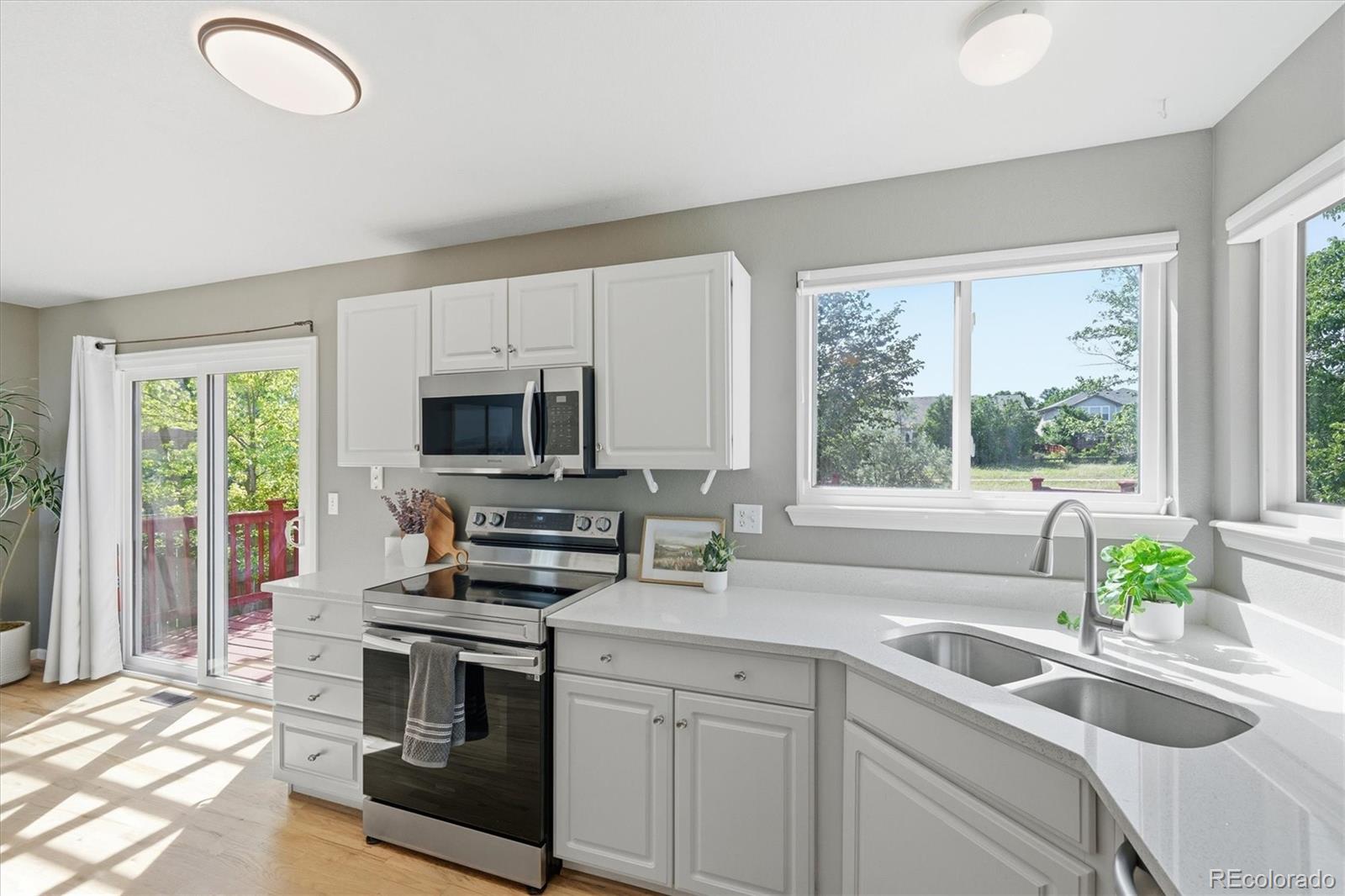 9629 Burberry Way Highlands Ranch, CO 80129 - Photo 17 of 50 a kitchen with appliances a sink and a window