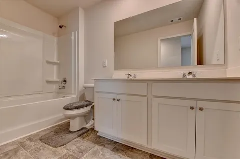 a bathroom with a sink toilet a mirror and shower