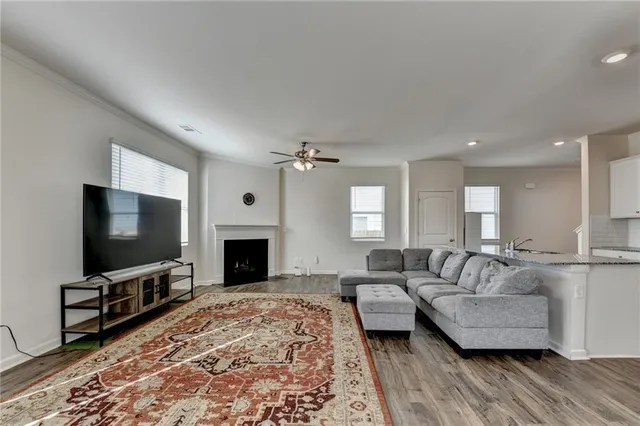 a kitchen with granite countertop wooden cabinets stove and sink