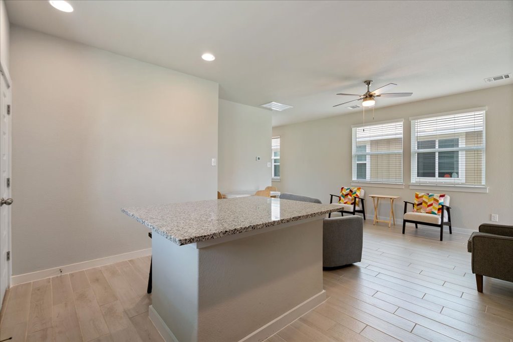 330 Hortus Drive Kyle, TX 78640 - Photo 12 of 26 a living room with granite countertop furniture a couch and wooden floor