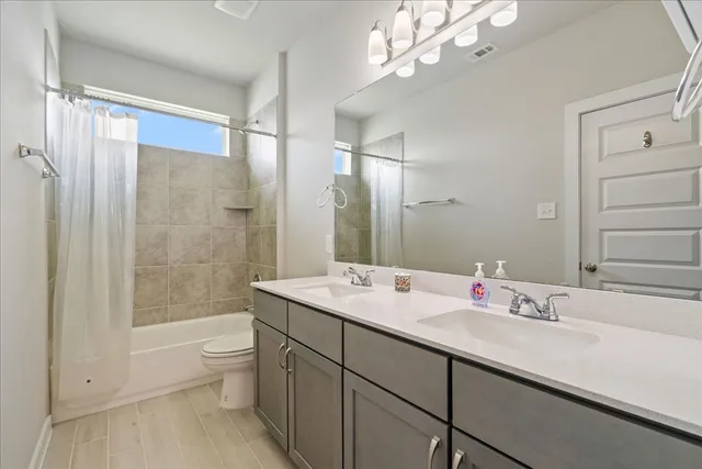 a bathroom with a double vanity sink mirror double shower and a bathtub