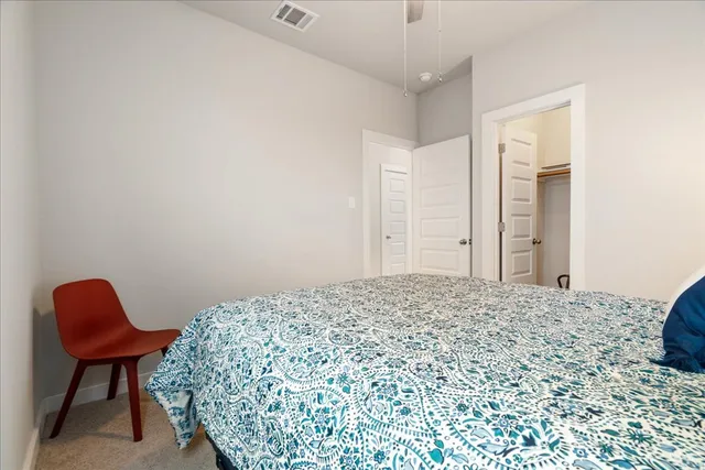 a bedroom with a bed and a chair