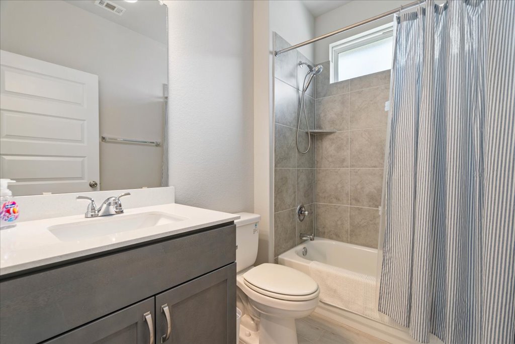 330 Hortus Drive Kyle, TX 78640 - Photo 19 of 26 a bathroom with a sink toilet and shower