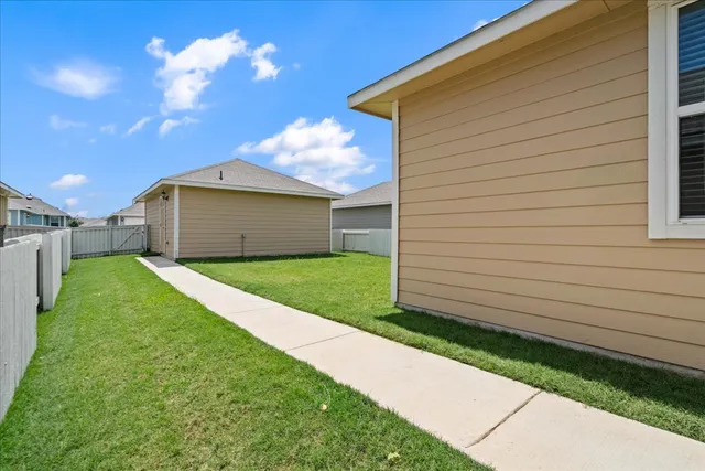 a front view of a house with a garden and yard