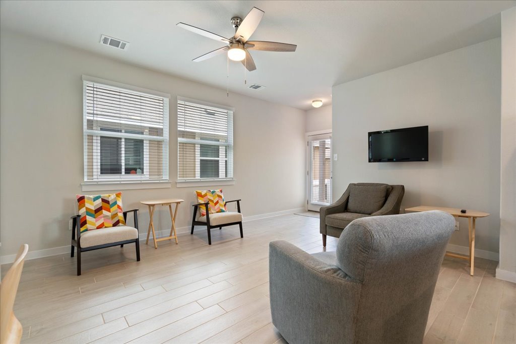 330 Hortus Drive Kyle, TX 78640 - Photo 8 of 26 a living room with furniture and a flat screen tv
