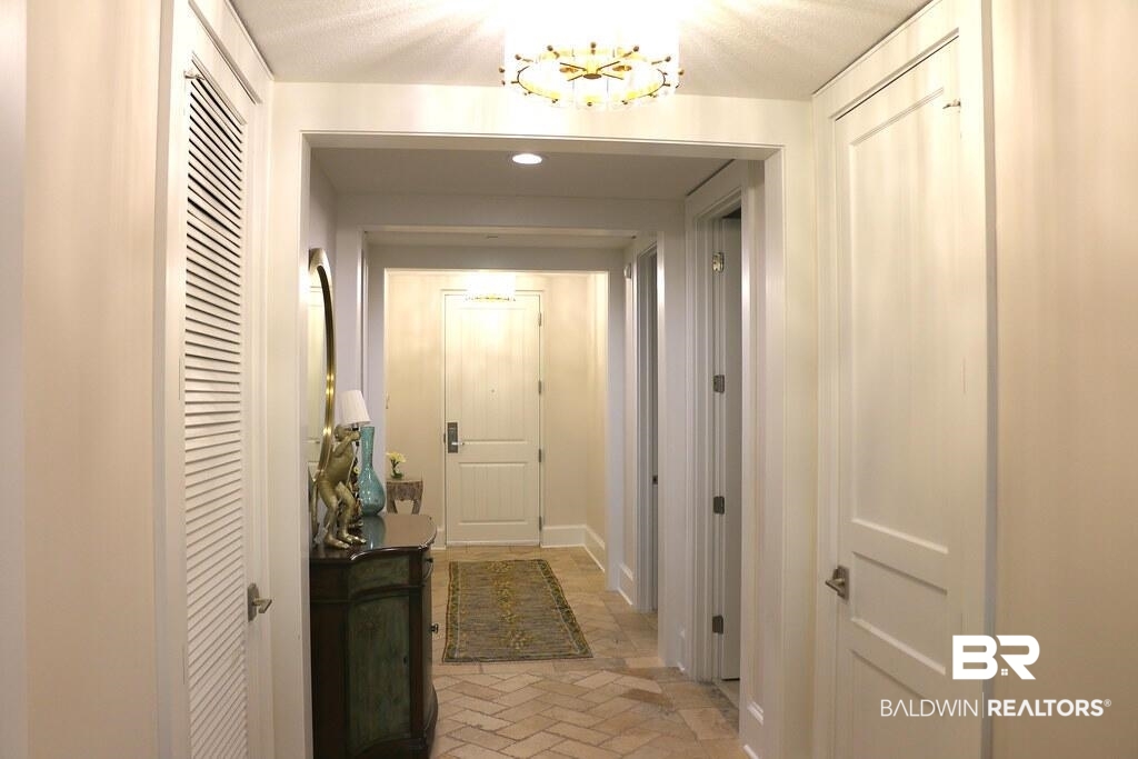 18269 Colony Drive, Unit 803 Fairhope, AL 36532 - Photo 13 of 27 Hallway featuring recessed lighting and brick flooring