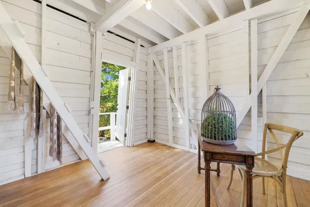 a view of a hallway with wooden floor and stairs