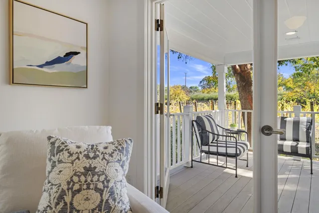 a front view of a house with swimming pool having outdoor seating