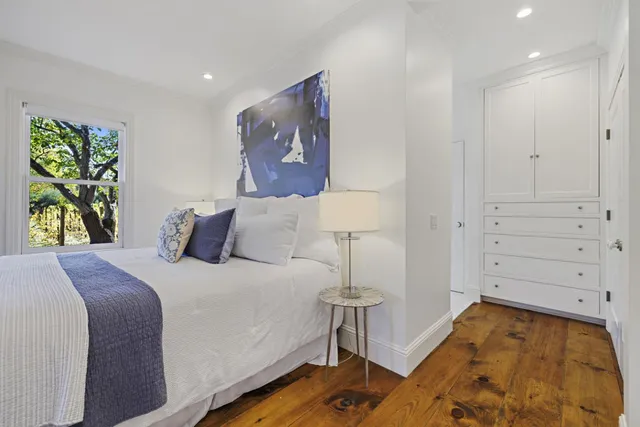 a view of a backyard with table and chairs under an umbrella