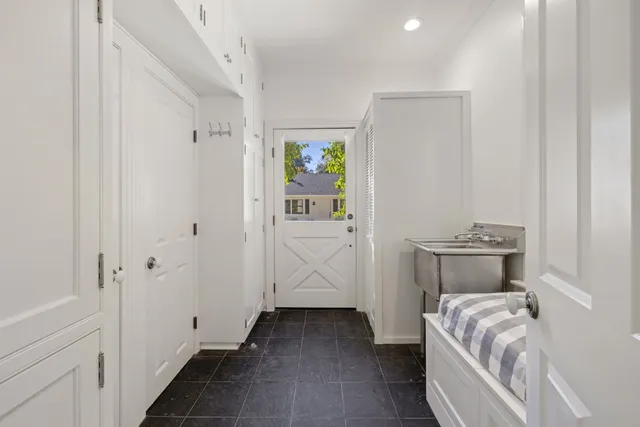 a living room with furniture and a piano