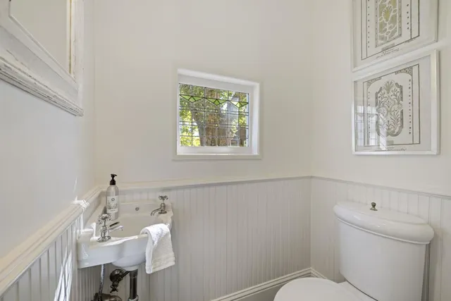 a front view of a house with a yard and potted plants