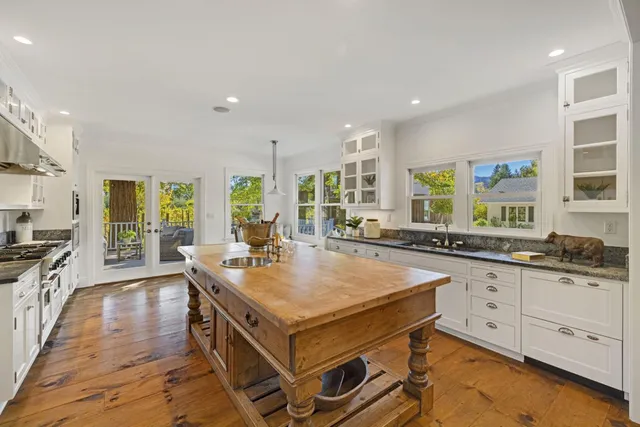 a front view of a house with a yard and green space