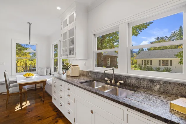 a front view of a house with a yard and garden