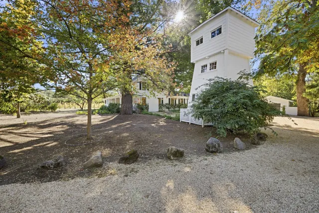 a bedroom with a large bed couch and a window