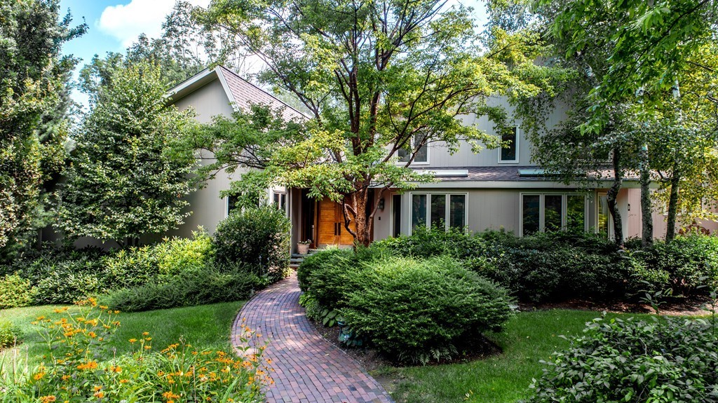 10 Rice Road Sudbury, MA 01776 - Photo 2 of 29 a front view of a house with a yard and shrubs