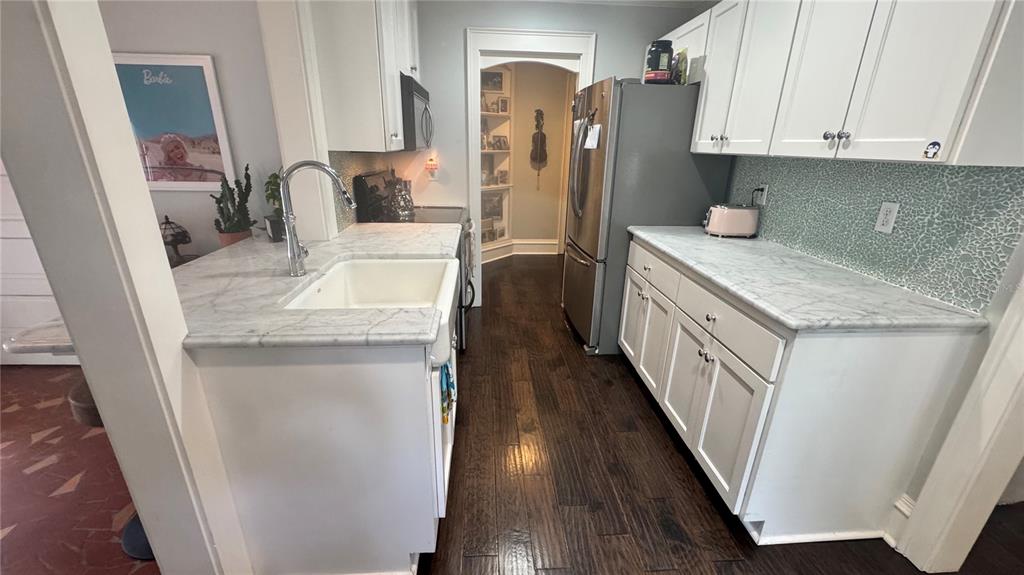433 Southeast 7th Street Gainesville, FL 32601 - Photo 2 of 28 a kitchen with sink a refrigerator and cabinets