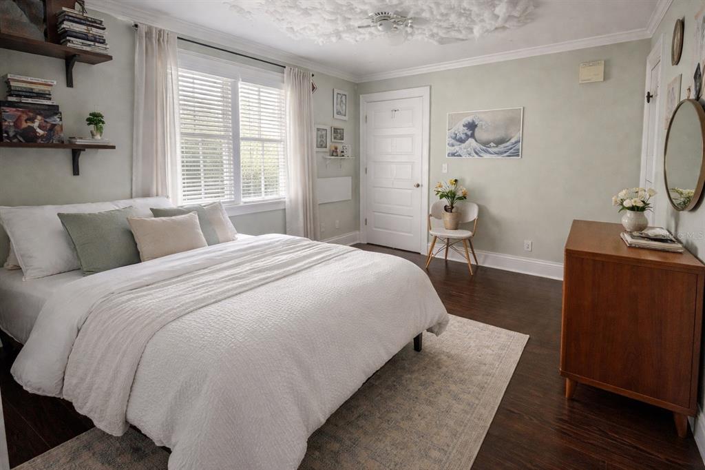 433 Southeast 7th Street Gainesville, FL 32601 - Photo 3 of 28 a bed room with a bed window and a chair