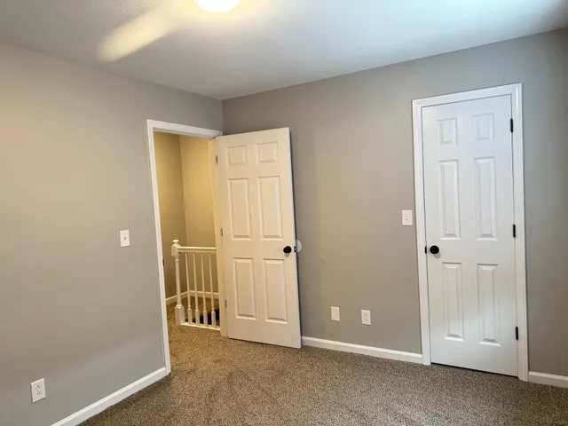 a bathroom with a white toilet and a shower