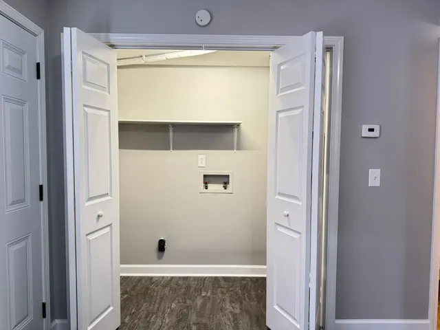 a white toilet sitting next to a shower