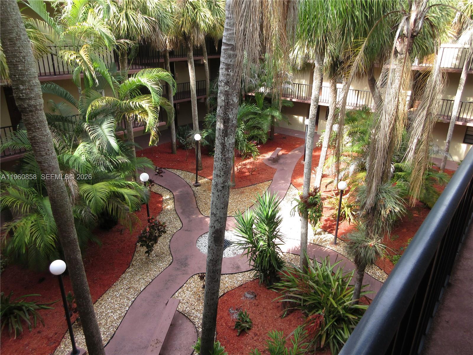 10835 Southwest 112th Avenue, Unit 305 Miami, FL 33176 - Photo 1 of 21 a view of a plant in front of a house