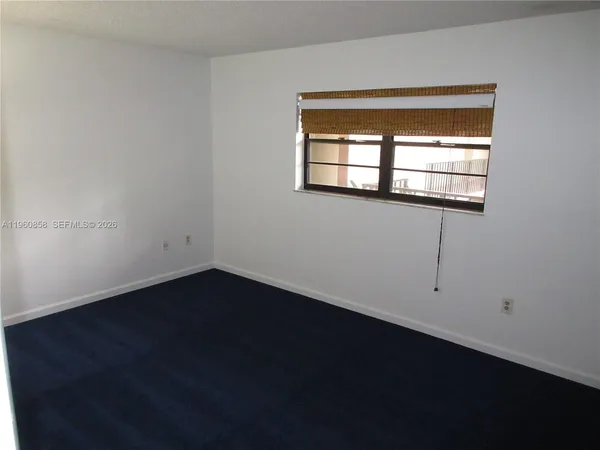 a view of an empty room with windows