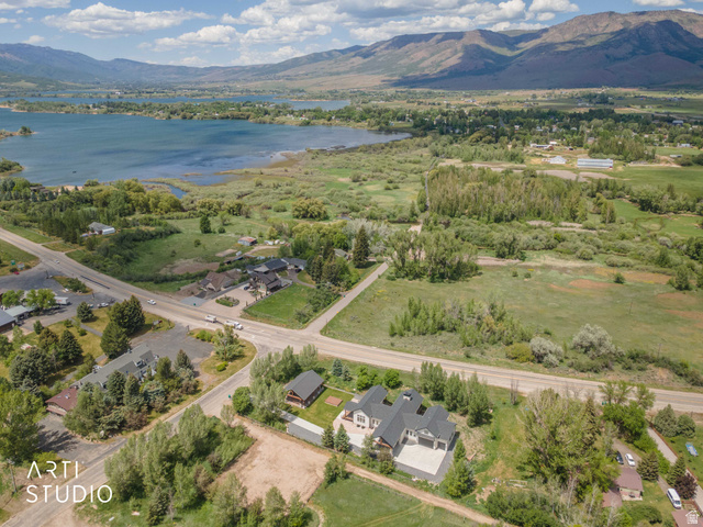 1188 South Old Trappers Loop Road Huntsville, UT 84317 - Photo 87 of 92 Sprawling property featuring a multi-level residence with dark roofing, multiple garage doors, and an extensive paved driveway