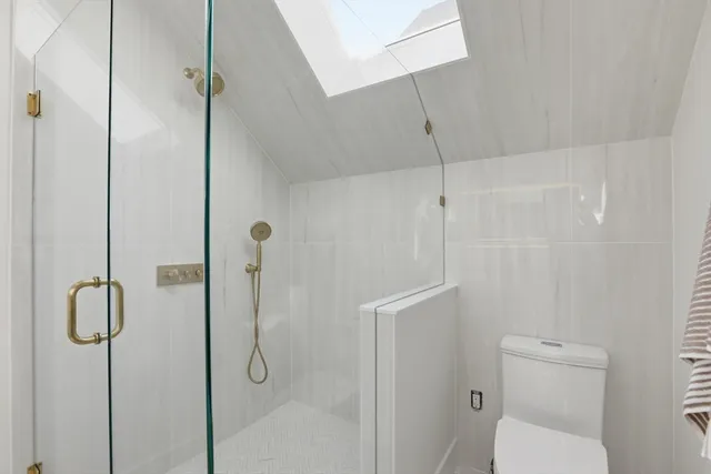 a bathroom with a shower and toilet