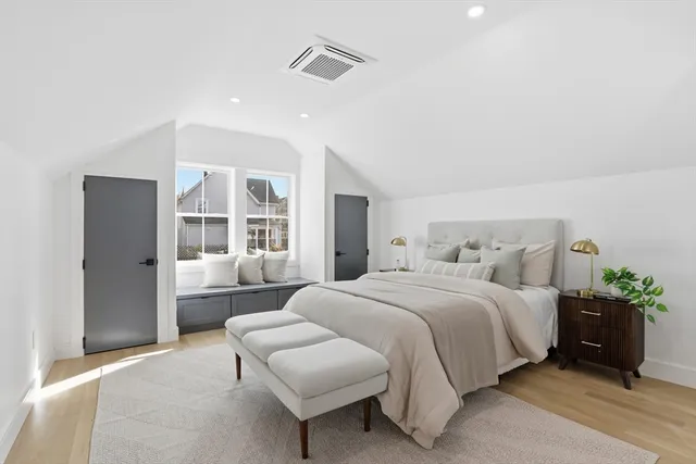 a bedroom with bed and a large window