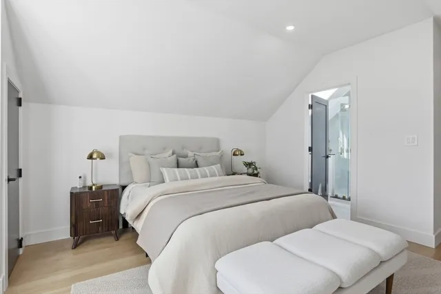 a bedroom with a bed and a night stand