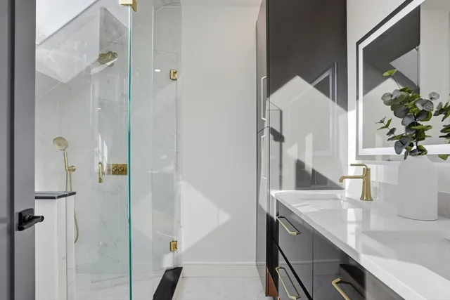 a bathroom with a granite countertop shower and a sink