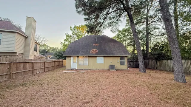 front view of a house with a large tree