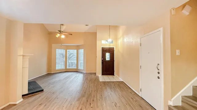 a view of a room with wooden floor