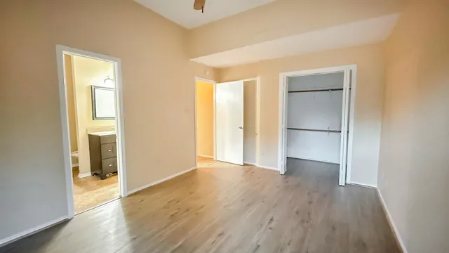 an empty room with wooden floor and a window