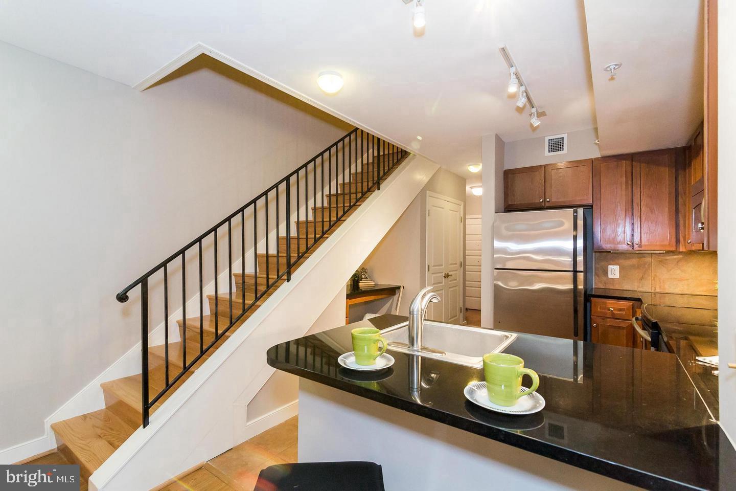 616 E Street Northwest, Unit 246 Washington, DC 20004 - Photo 12 of 40 a kitchen with stainless steel appliances granite countertop a sink and refrigerator