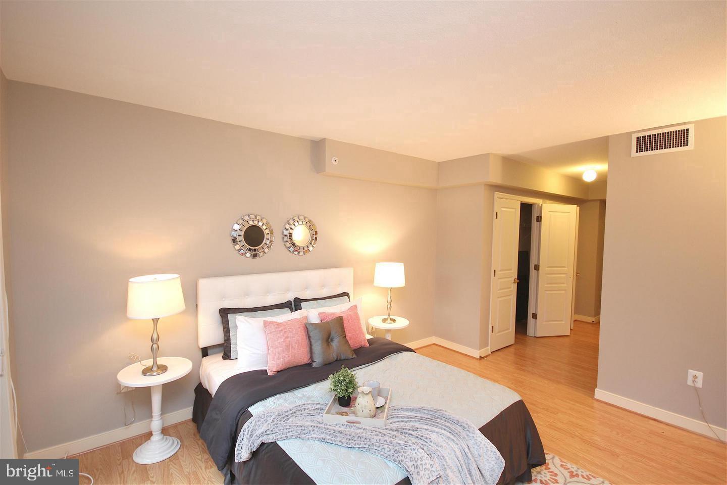 616 E Street Northwest, Unit 246 Washington, DC 20004 - Photo 15 of 40 a bedroom with a bed and wooden floor