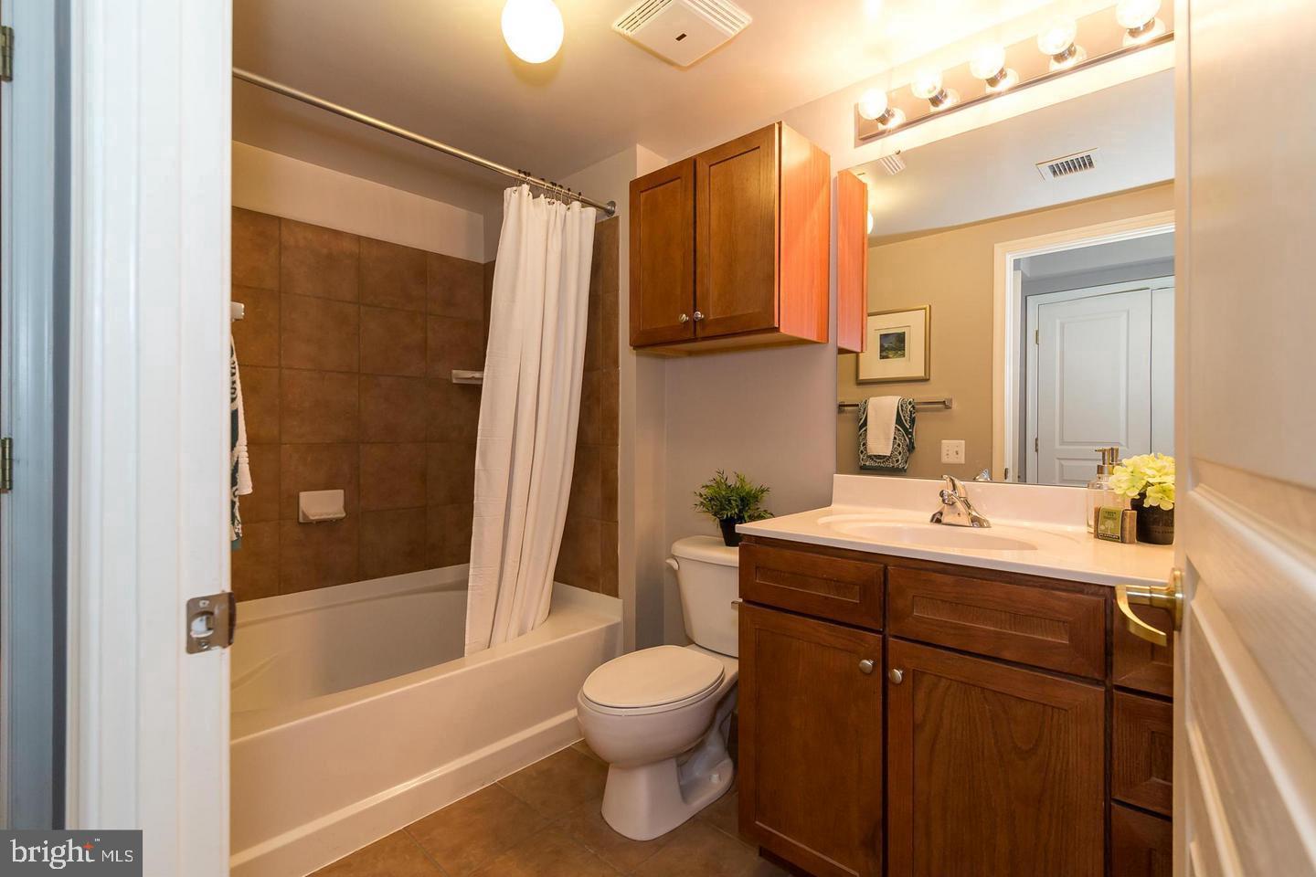 616 E Street Northwest, Unit 246 Washington, DC 20004 - Photo 16 of 40 a bathroom with a sink a toilet and shower