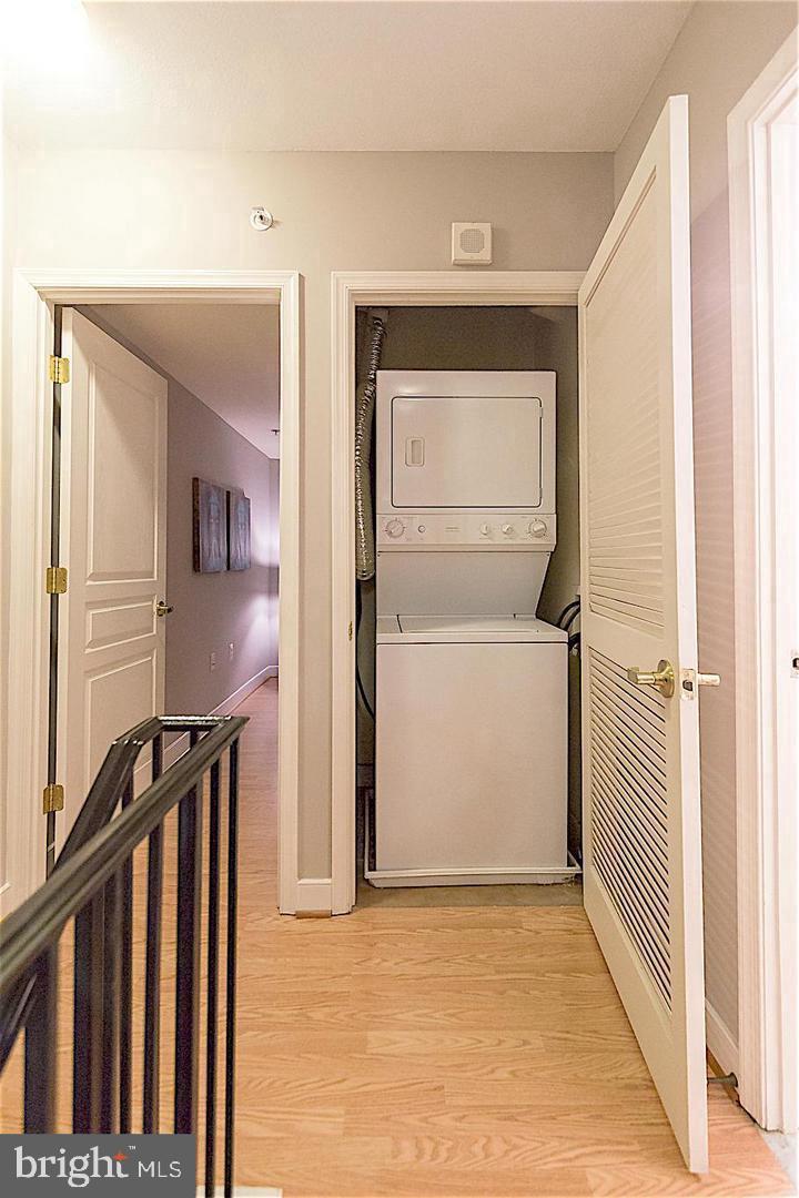 616 E Street Northwest, Unit 246 Washington, DC 20004 - Photo 17 of 40 a view of a hallway with wooden floor and staircase