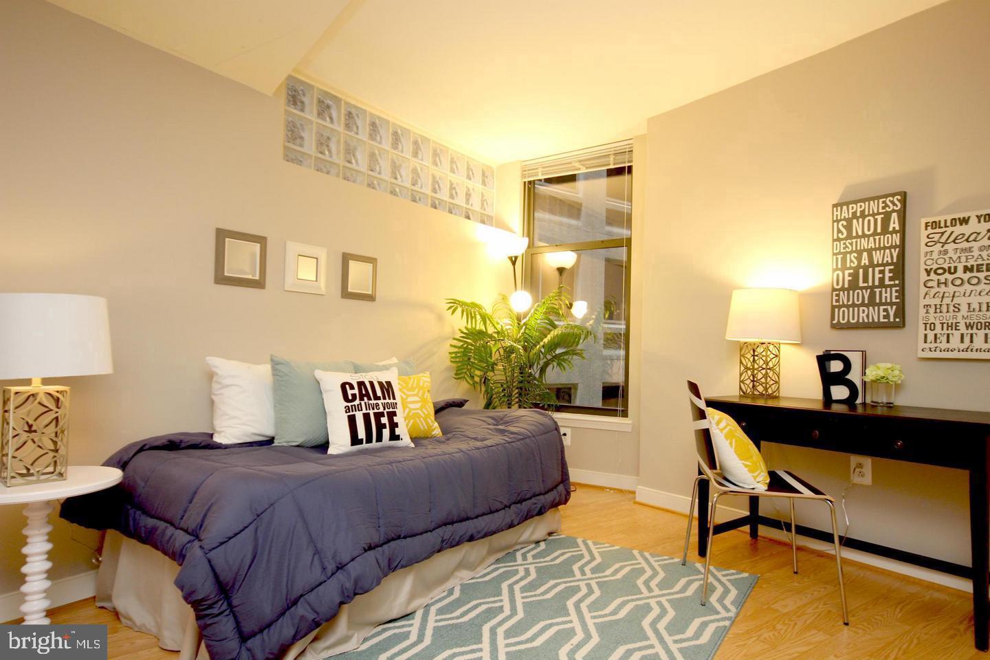 616 E Street Northwest, Unit 246 Washington, DC 20004 - Photo 19 of 40 a bedroom with a bed and wooden floor