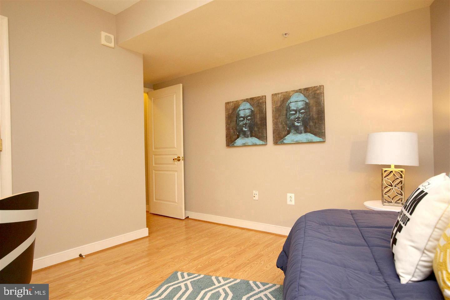 616 E Street Northwest, Unit 246 Washington, DC 20004 - Photo 20 of 40 a bed room with a bed and a lamp